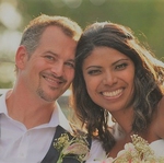 A wedding couple huddled closely for photo